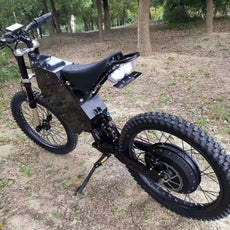 72v 3000w stealth bomber bike with motorcycle seat, black motorcycle wheel, frame, hydraulic disc brake on mountain trail